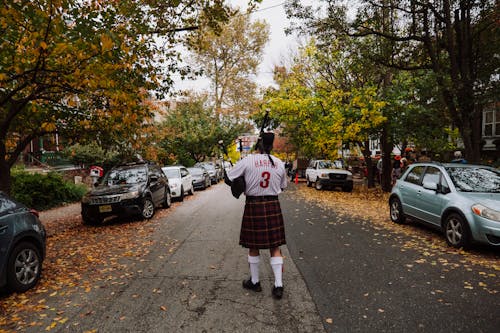 Man Walking in a Kilt and a Soccer Shirt