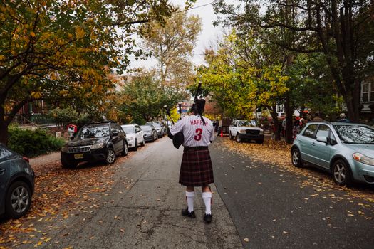 Man Walking in a Kilt and a Soccer Shirt