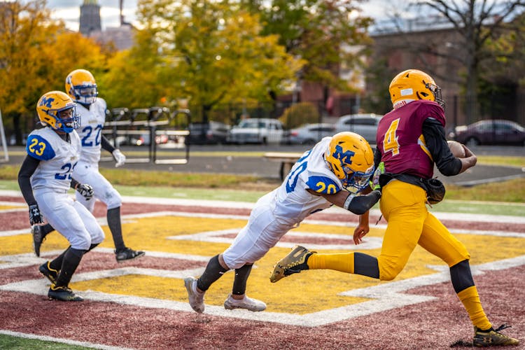 A Football Player Tackling The Enemy