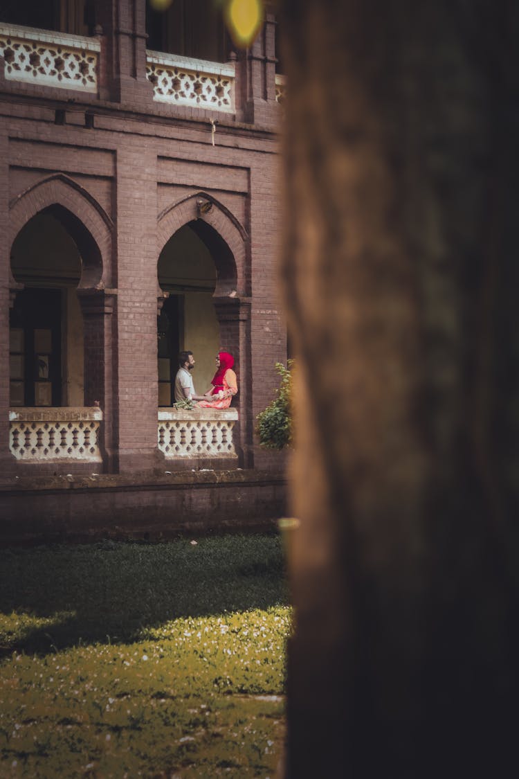 A Couple Talking At The Balcony