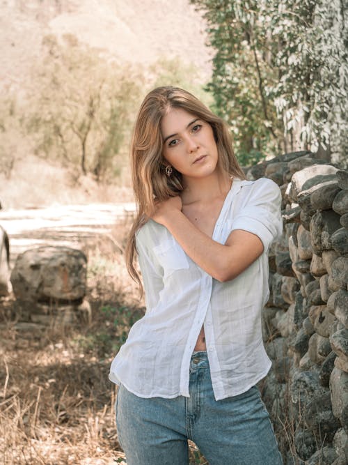 Young Blonde Woman in White Shirt and Jeans