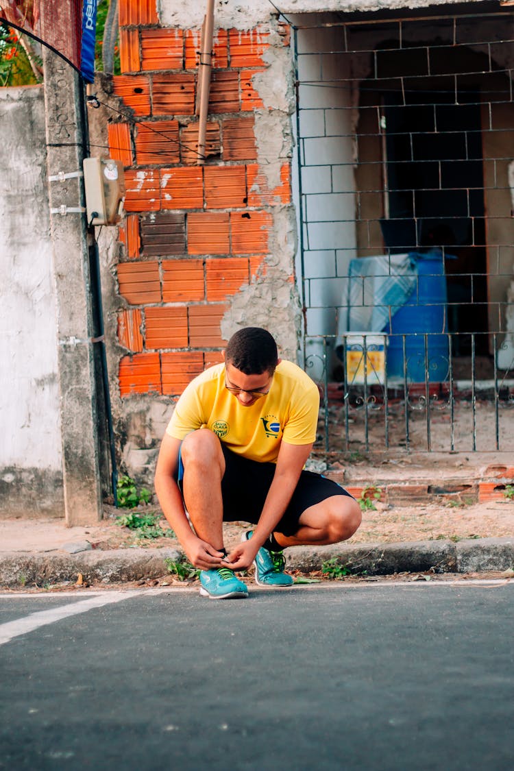 A Man Tying His Shoelace