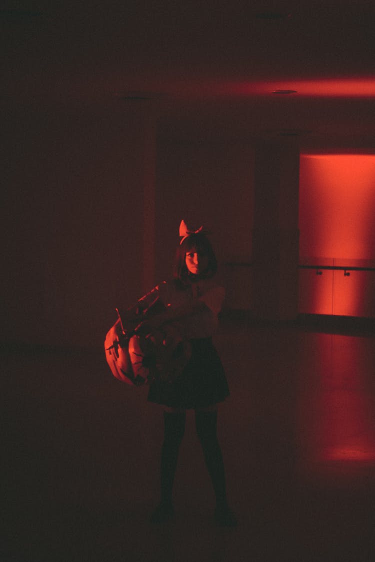 Woman Standing In Dimly Lit Empty Room