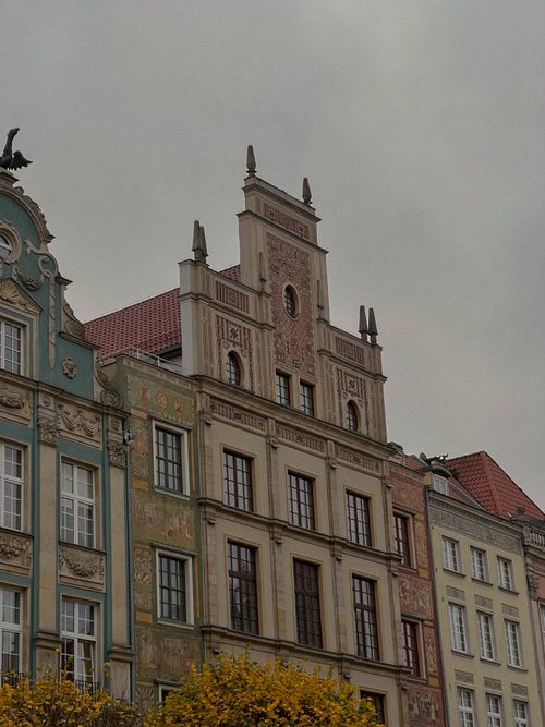 Free Ornate facade of historic buildings in Gdańsk, Poland under a gray sky. Stock Photo