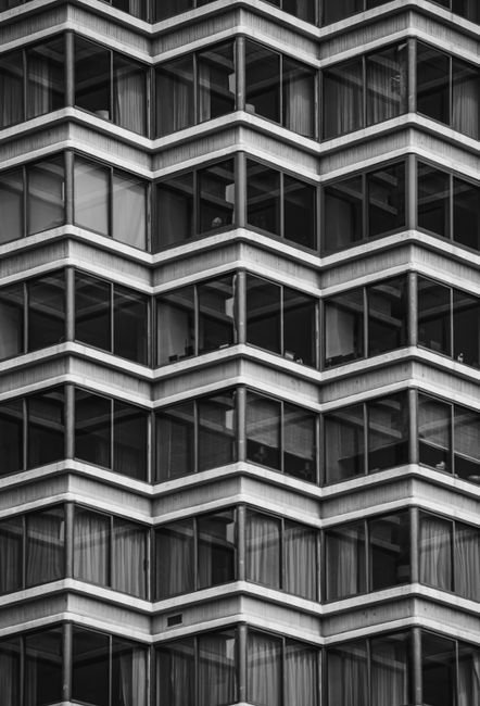 Black and white view of a geometric facade pattern with glass windows in Philadelphia.