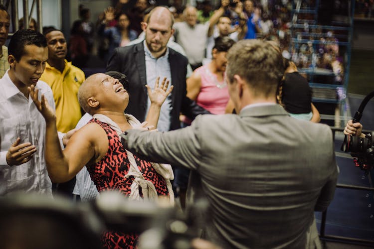 Man Standing Beside A Bald Woman Crying