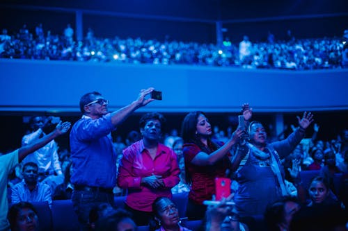 People in a Stadium Taking Photos