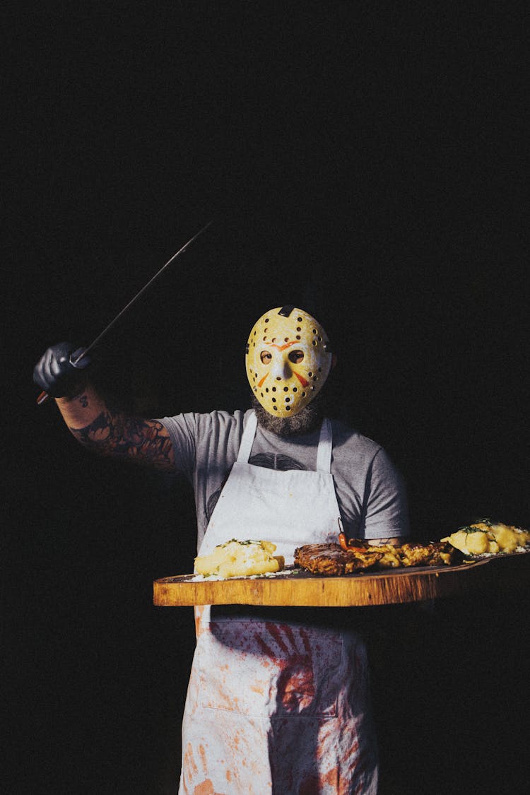 Man In Butcher Costume With Meat Board