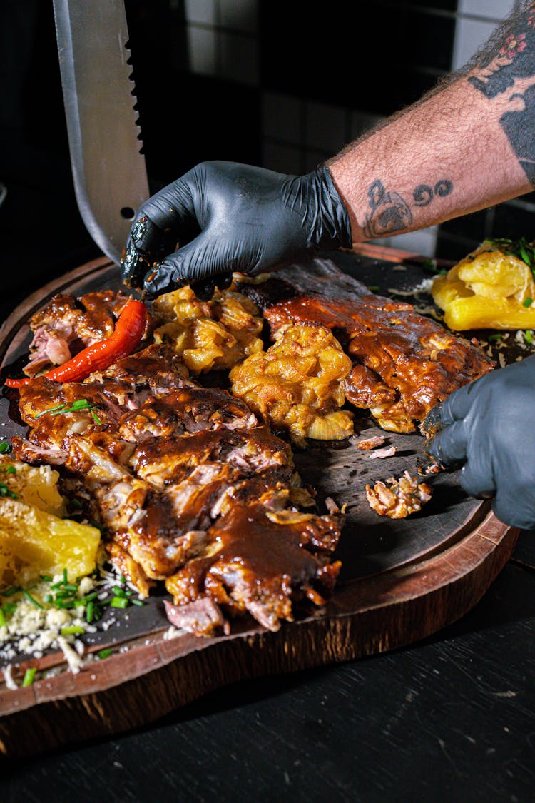 Hands In Gloves Near Meat Board