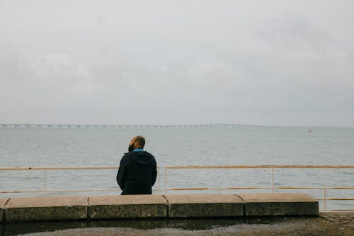 A Man Sitting at the Esplanade