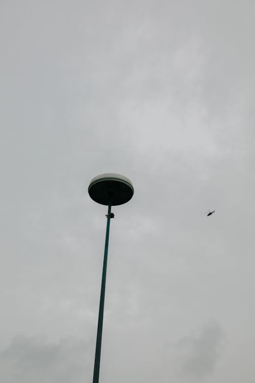 Low Angle Shot of a Streetlight against a Cloudy Sky 