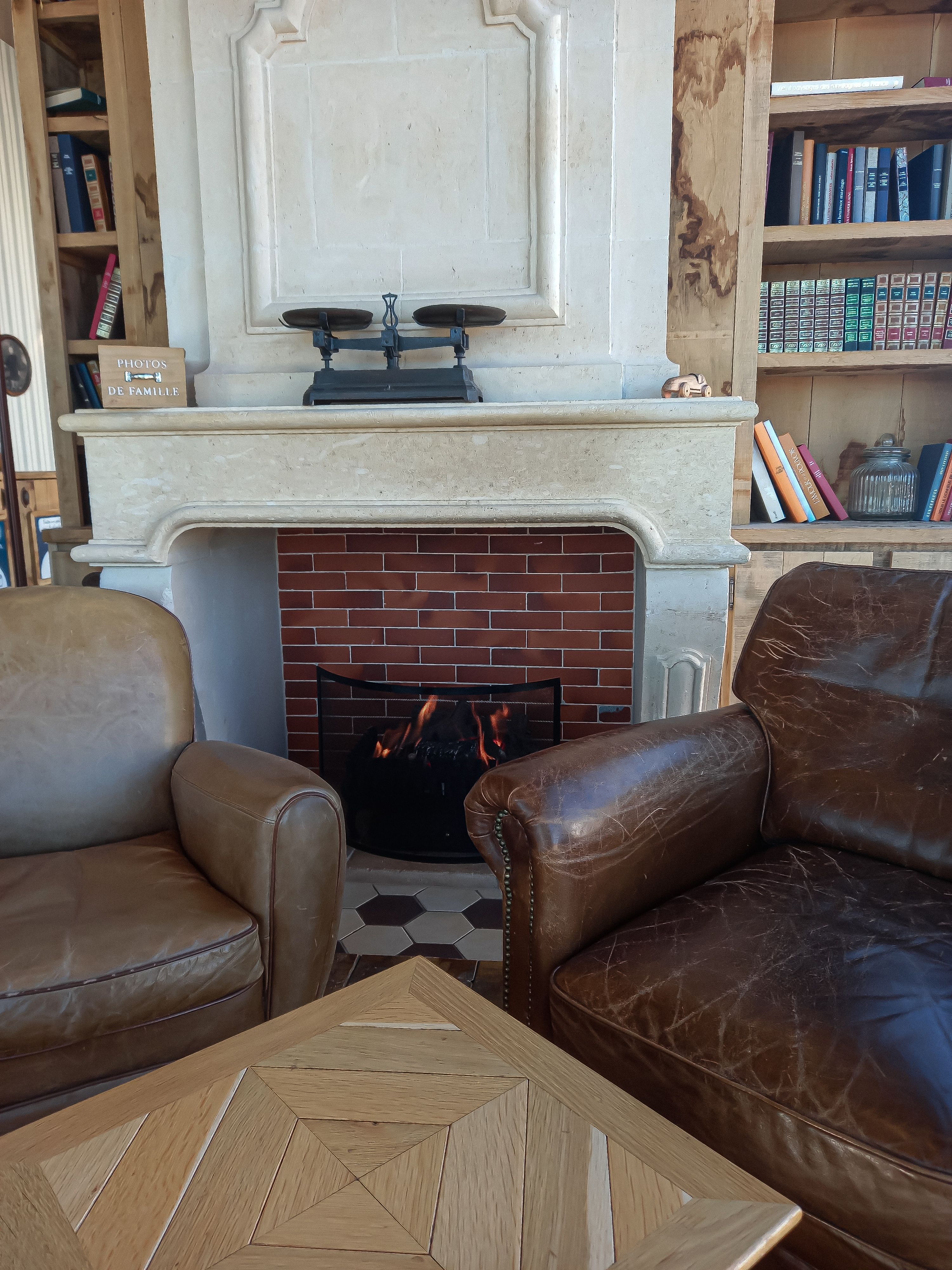 Artist's impression: warm residents lounge with a stone fireplace, oak and linen.