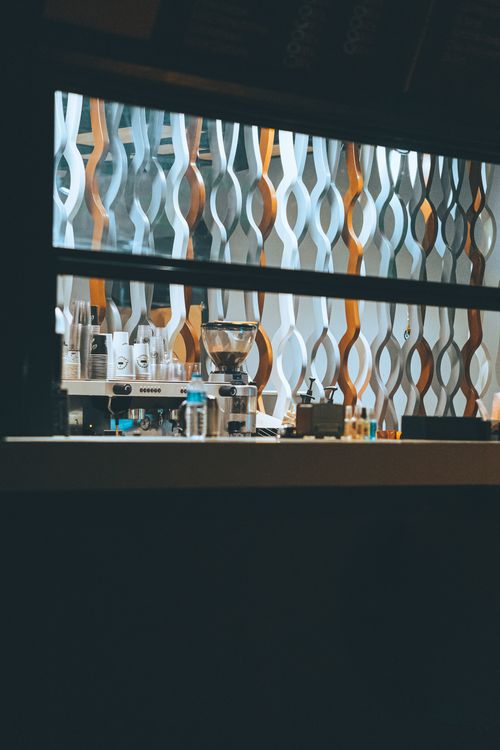 Free A stylish coffee shop interior seen through a window, illuminated at night. Stock Photo