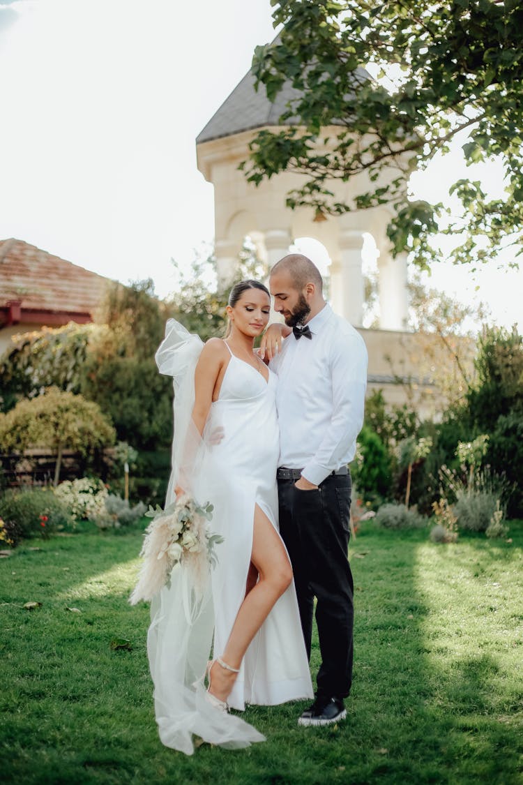 Bride And Groom Posing In Garden