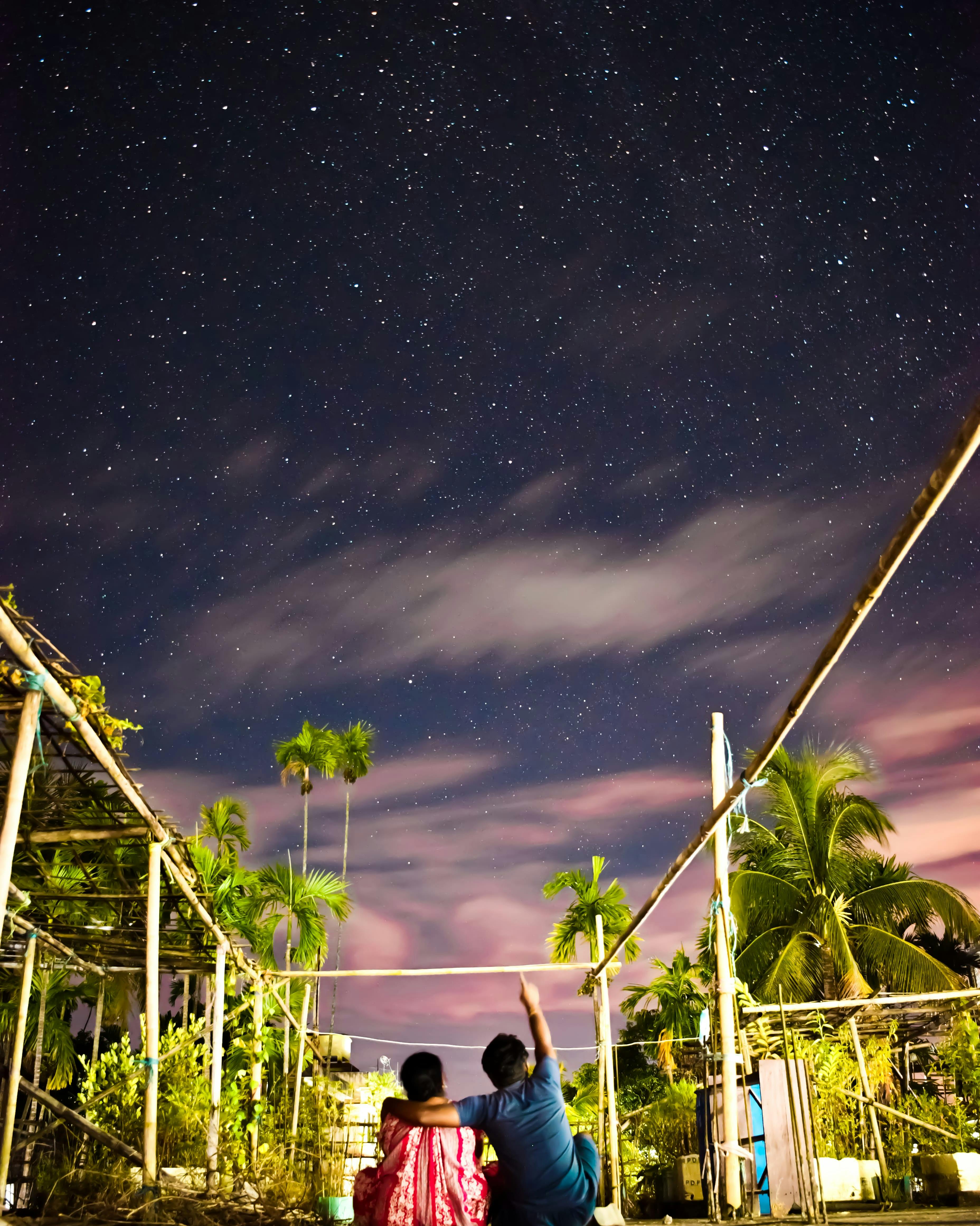 mother and son looking at stars in night sky