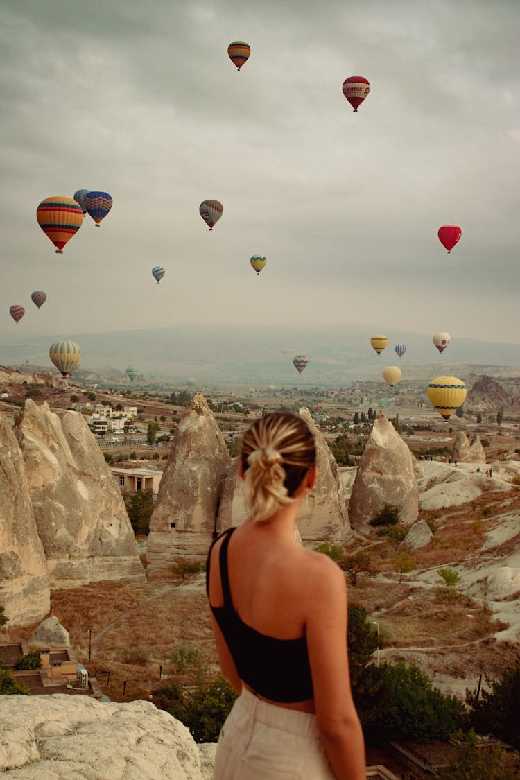 Woman In Black Tank Top Standing Near Hot Air Balloons