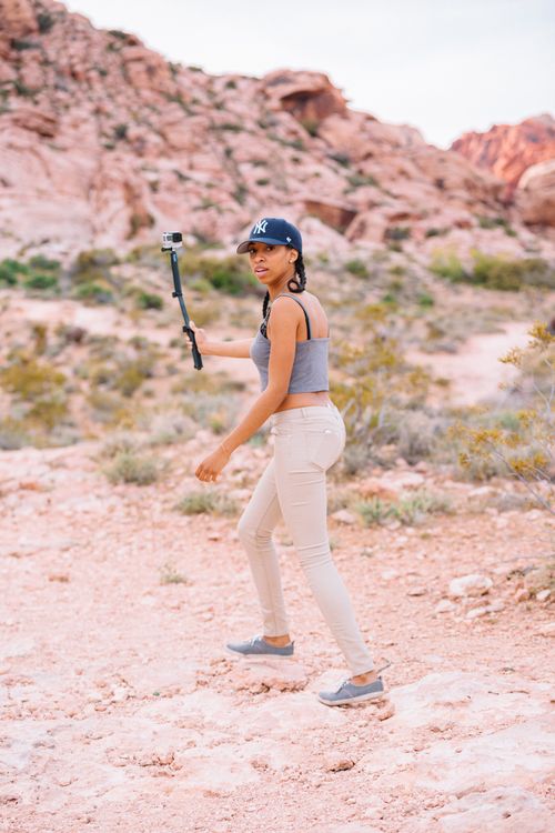Free A young woman capturing a vlog with an action camera in Red Rock Canyon near Las Vegas. Stock Photo