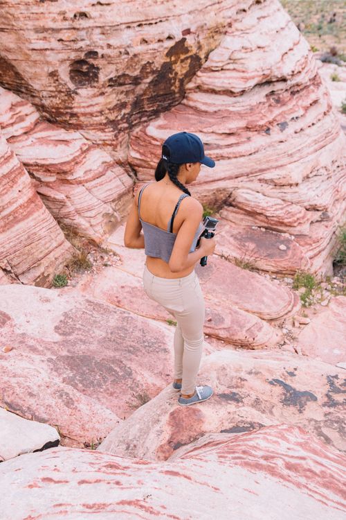 Woman Standing on Brown Rock Formation · Free Stock Photo