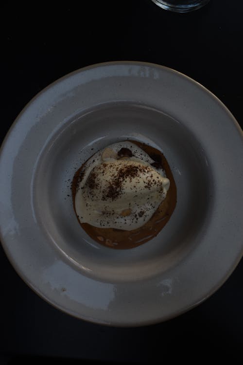 Photo of a Ball of Ice Cream Served in a Deep Plate