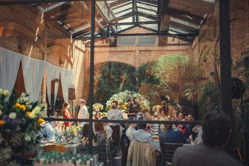 Wedding Guests Sitting the the Tables and Eating 