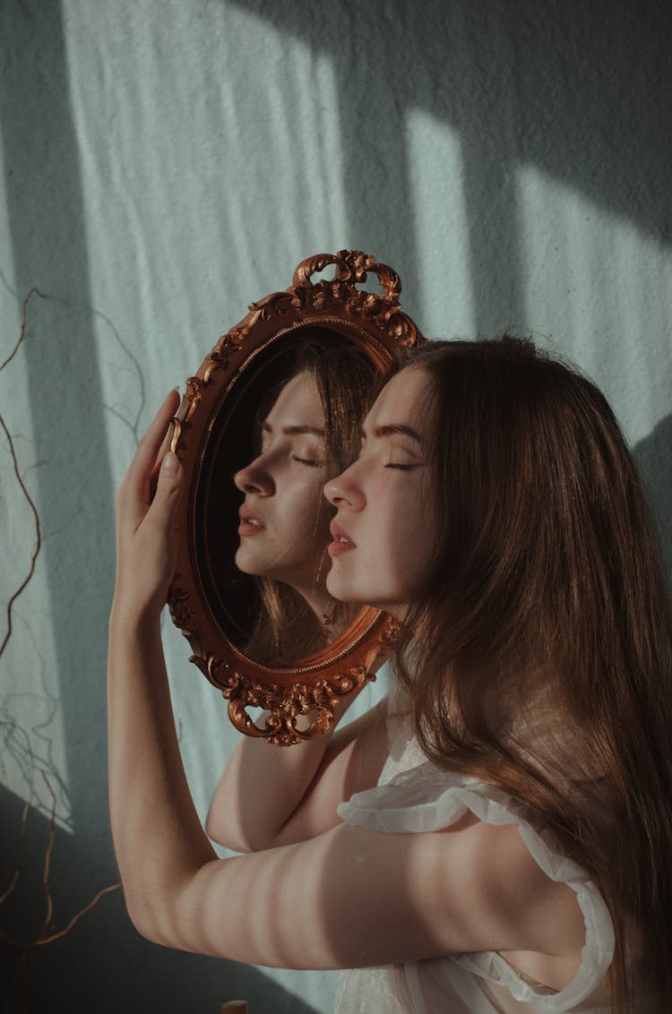 A Woman Holding A Mirror