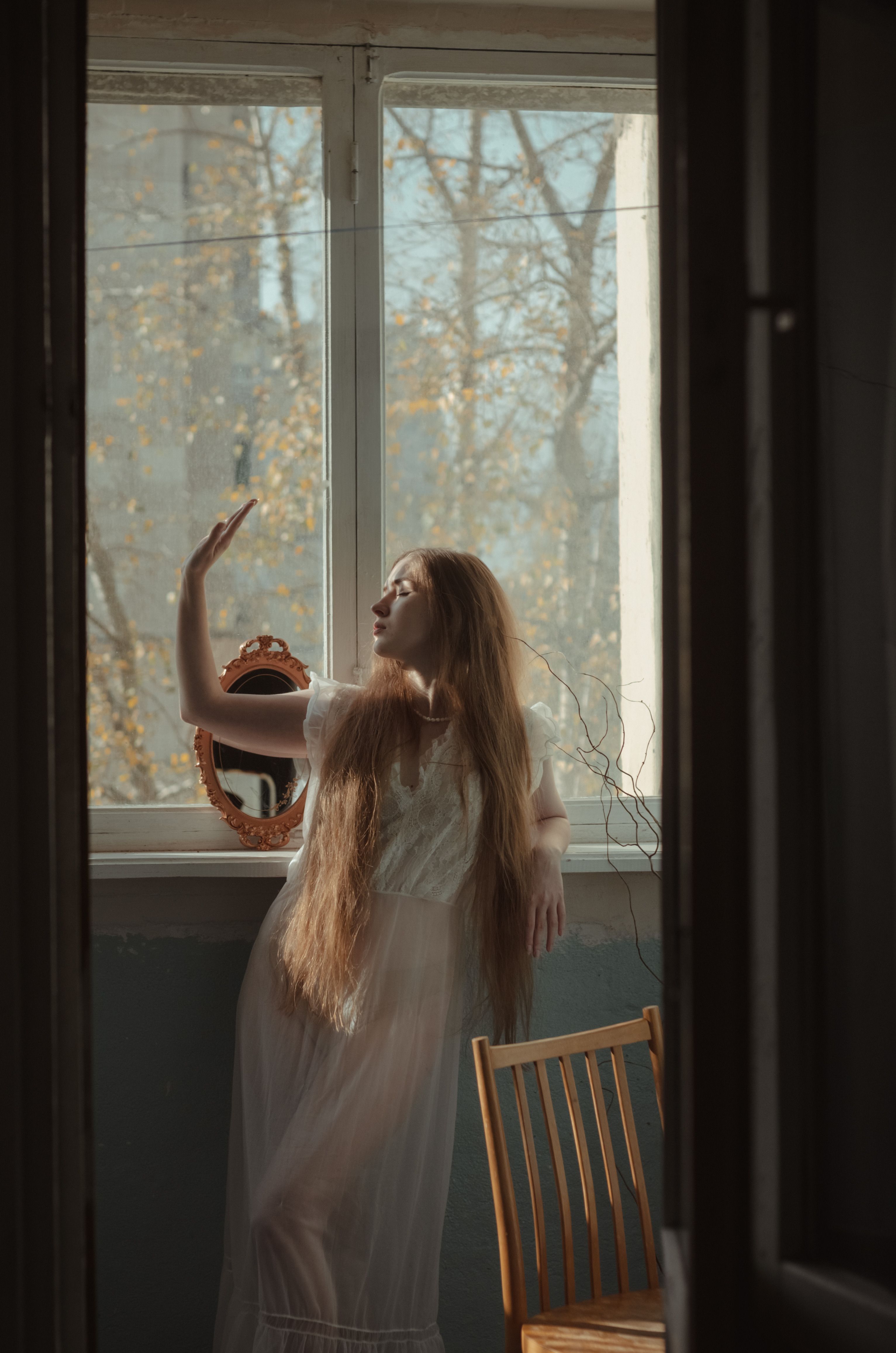 A Woman in White Dress Standing Beside the Glass Window · Free Stock Photo