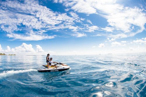 Free Enjoy a thrilling jet ski ride in the serene waters of Kaafu Atoll, Maldives. Stock Photo