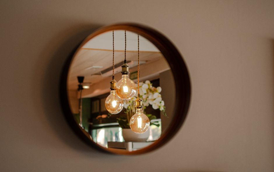 Spiegel reflecteert zonlicht in zonnige woonkamer. Spiegel reflecteert zonlicht in zonnige woonkamer.