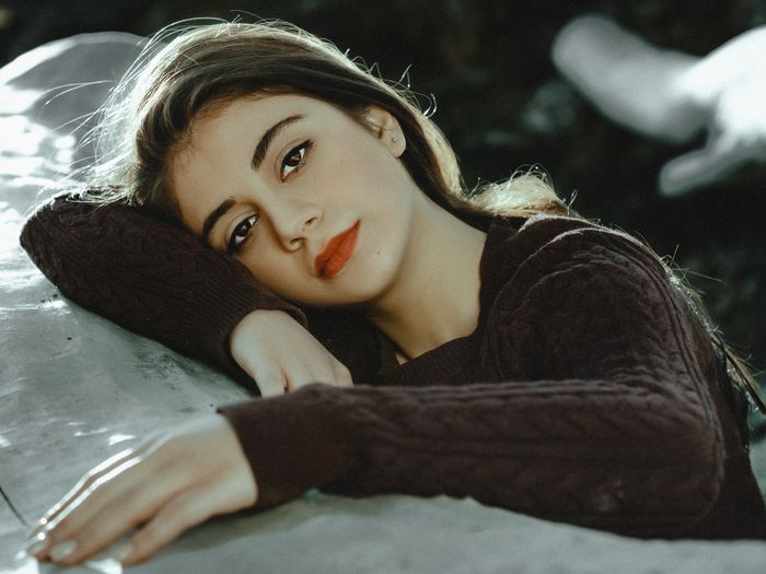 Close-up of a person in a cozy knitted sweater outdoors. Photo by A K on Pexels