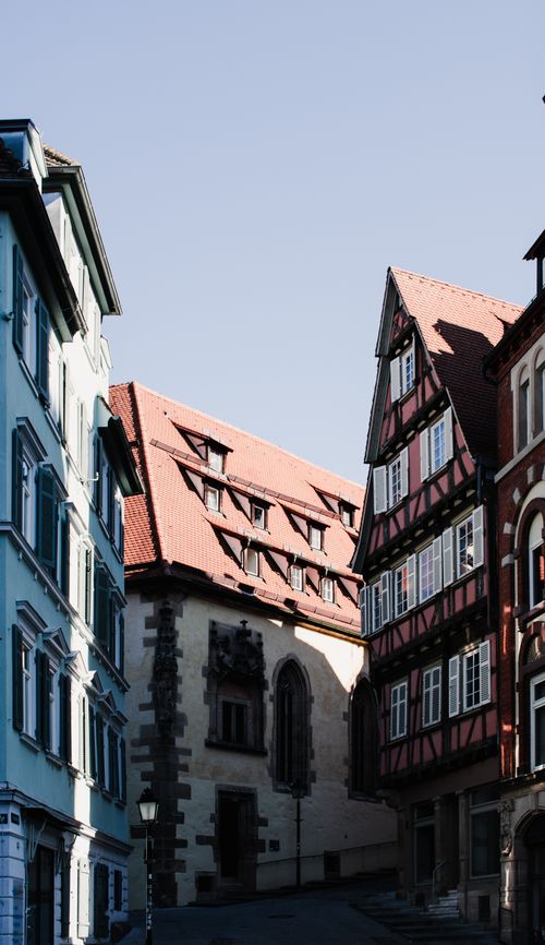 Free Picturesque alley in Tübingen, Germany with traditional architecture and sunlight. Stock Photo