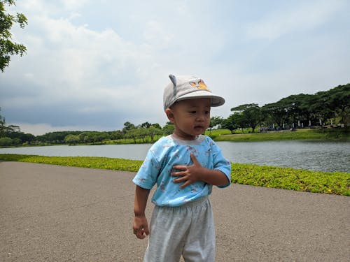 Close-up of a Young Child with Hand on Chest