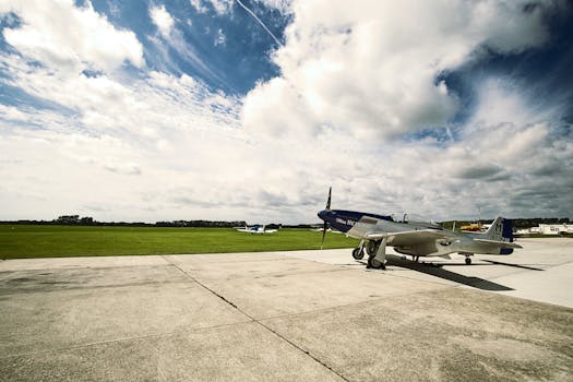 A vintage aircraft parked on an airfield in West Sussex, under a beautifully clouded sky.