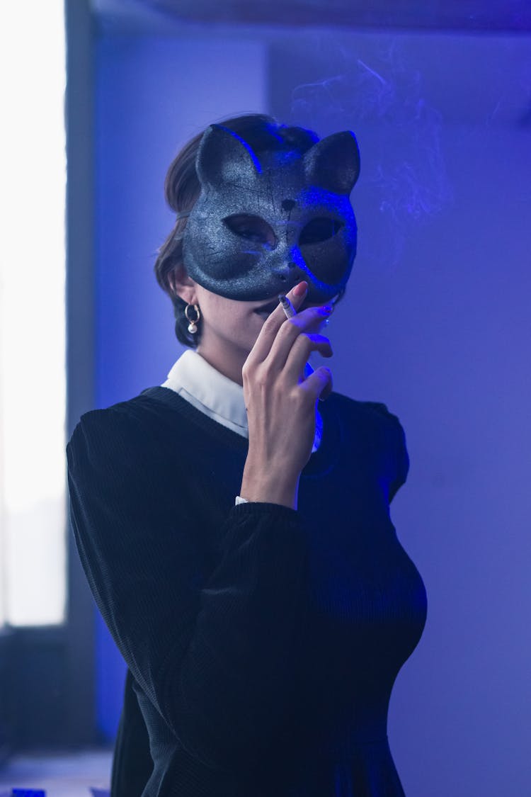 Woman In Mask Smoking Cigarette