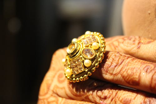 Person Wearing Gold-colored Ring