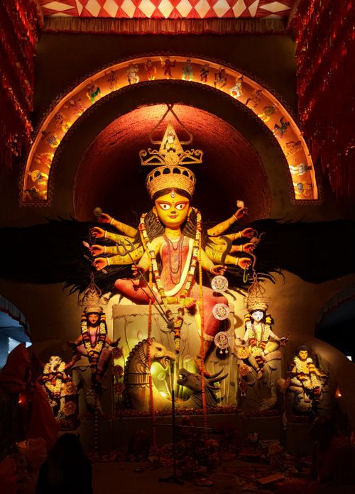 Free Illuminated statue of Goddess Durga in a traditional Kolkata temple during a cultural fest. Stock Photo