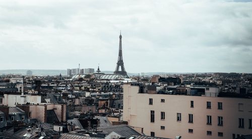 Free Stunning view of Paris with the iconic Eiffel Tower against a cloudy sky. Stock Photo