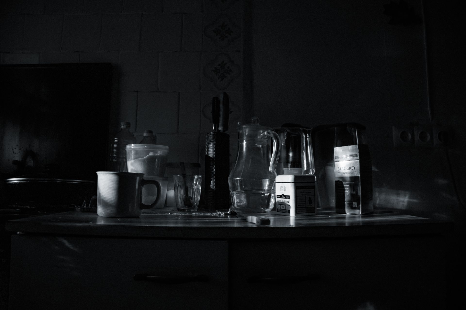 A glass of water on a kitchen counter in morning light.