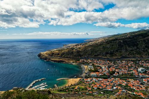 Free Stunning aerial view of Madeira's coastline, showcasing the harbor, marina, and scenic landscape. Stock Photo