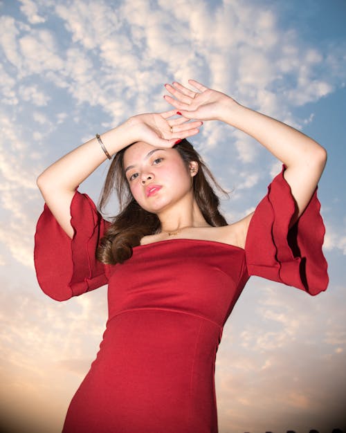 A Woman in Red Dress Posing at the Camera