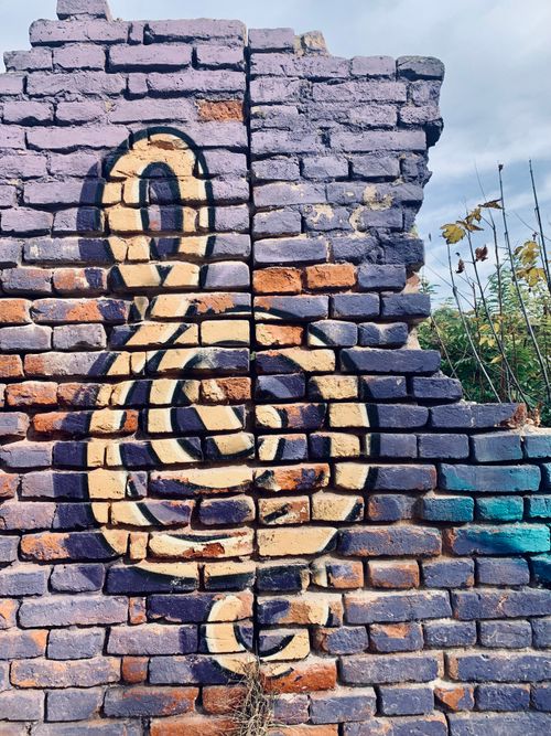 Free Vibrant street mural on a weathered brick wall in Niš, showcasing urban art. Stock Photo