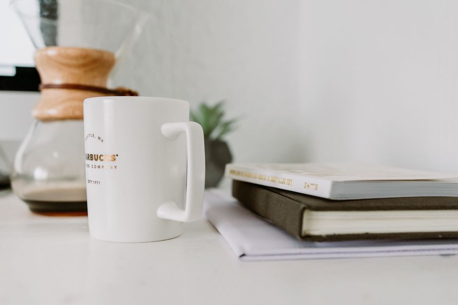 A serene workspace featuring coffee, books, and a Chemex for a productive morning.
