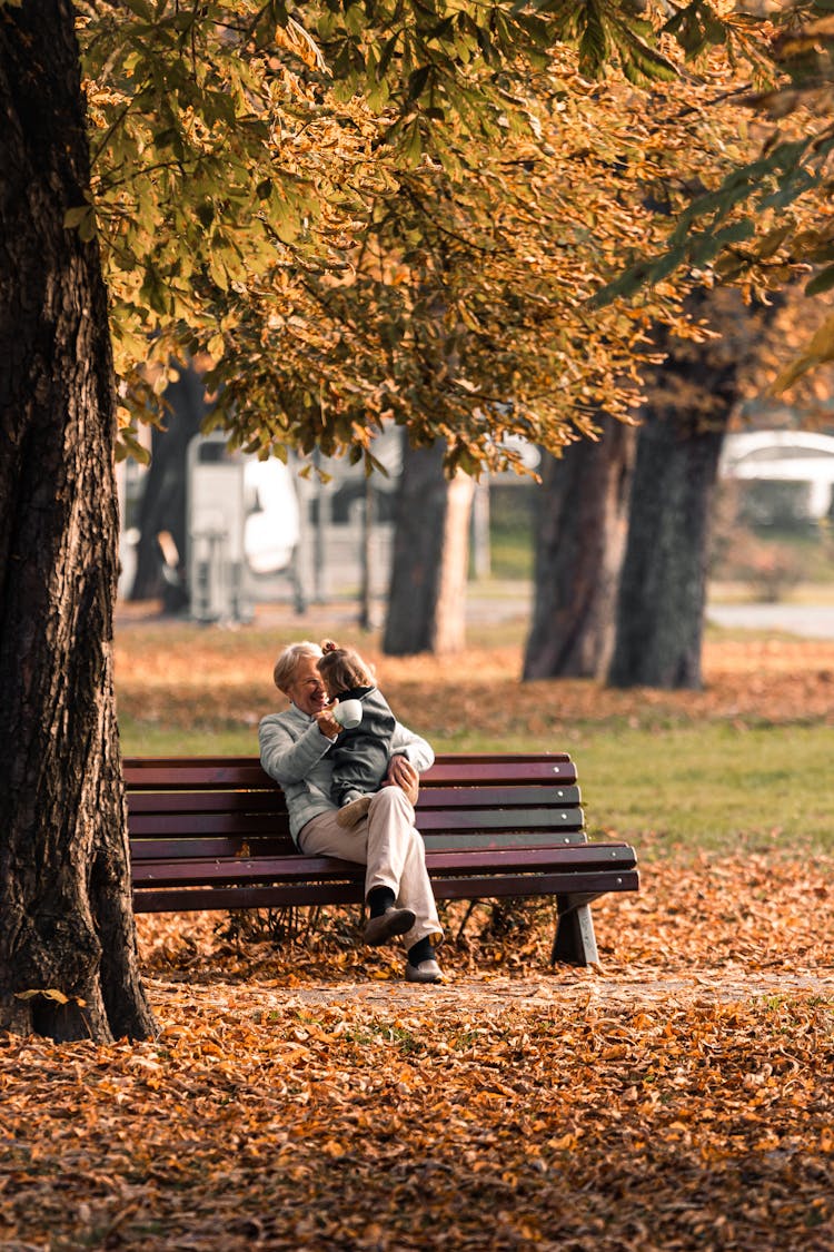 Grandma And Grandchild Sitting On The Bench