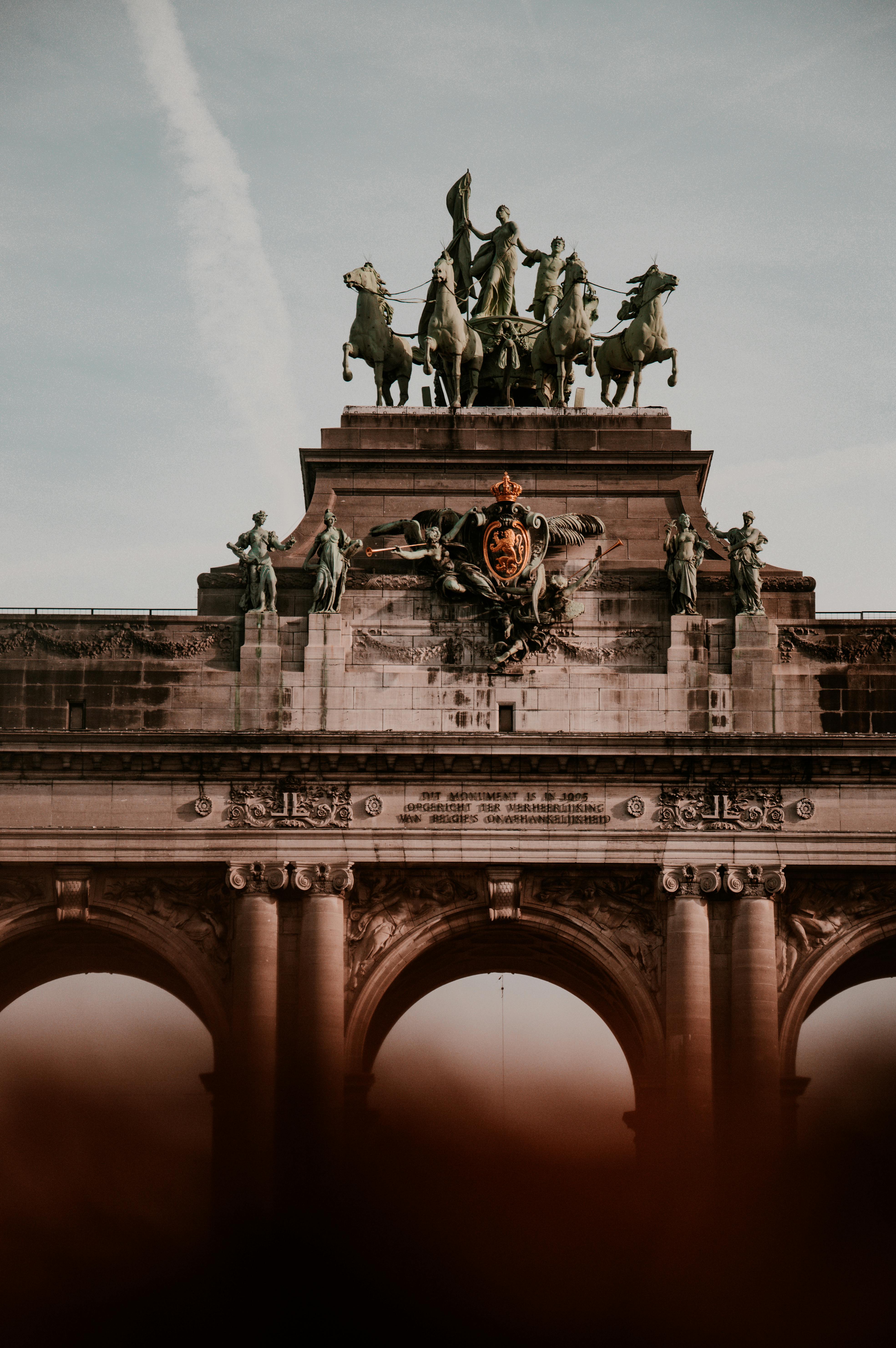 concrete statue on top of the concrete arch