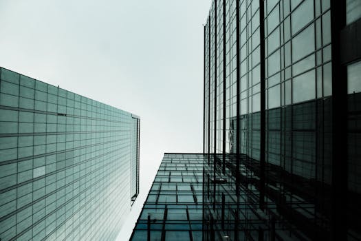 Low angle view of modern skyscrapers with glass facades in a cityscape.
