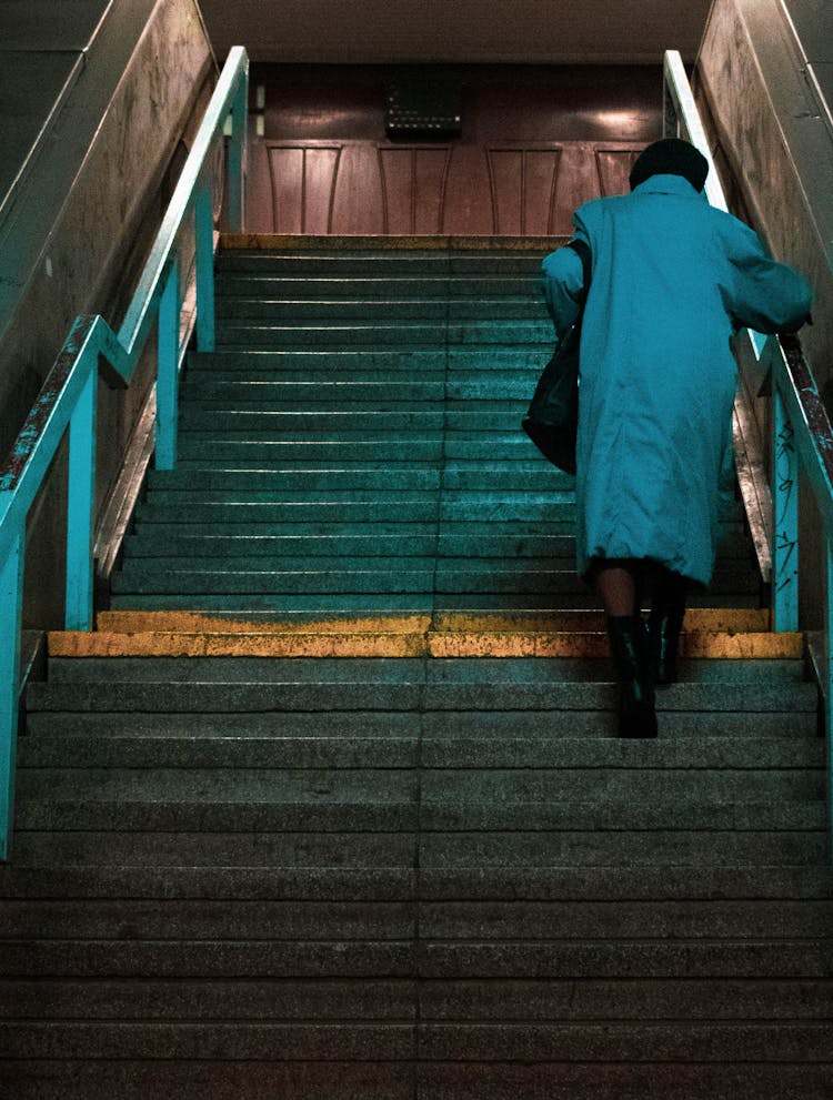 A Woman Climbing Up The Stairs