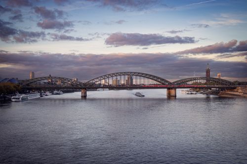 Free Aerial view of the Hohenzollern Bridge and Rhine River in Cologne, Germany at dusk. Stock Photo