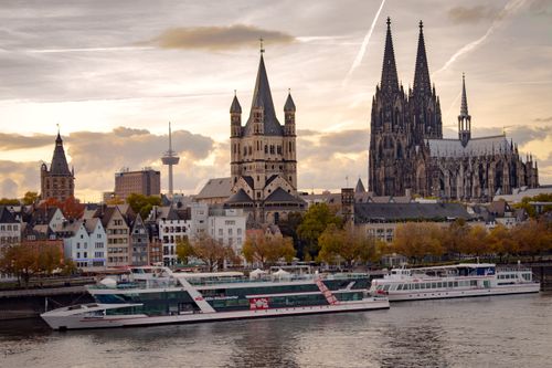 Free Beautiful skyline of Cologne with famous landmarks and boats on the Rhine River. Stock Photo