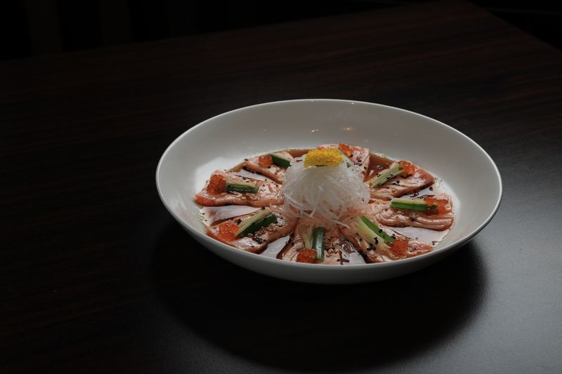 Elegant salmon sashimi plated with garnishes