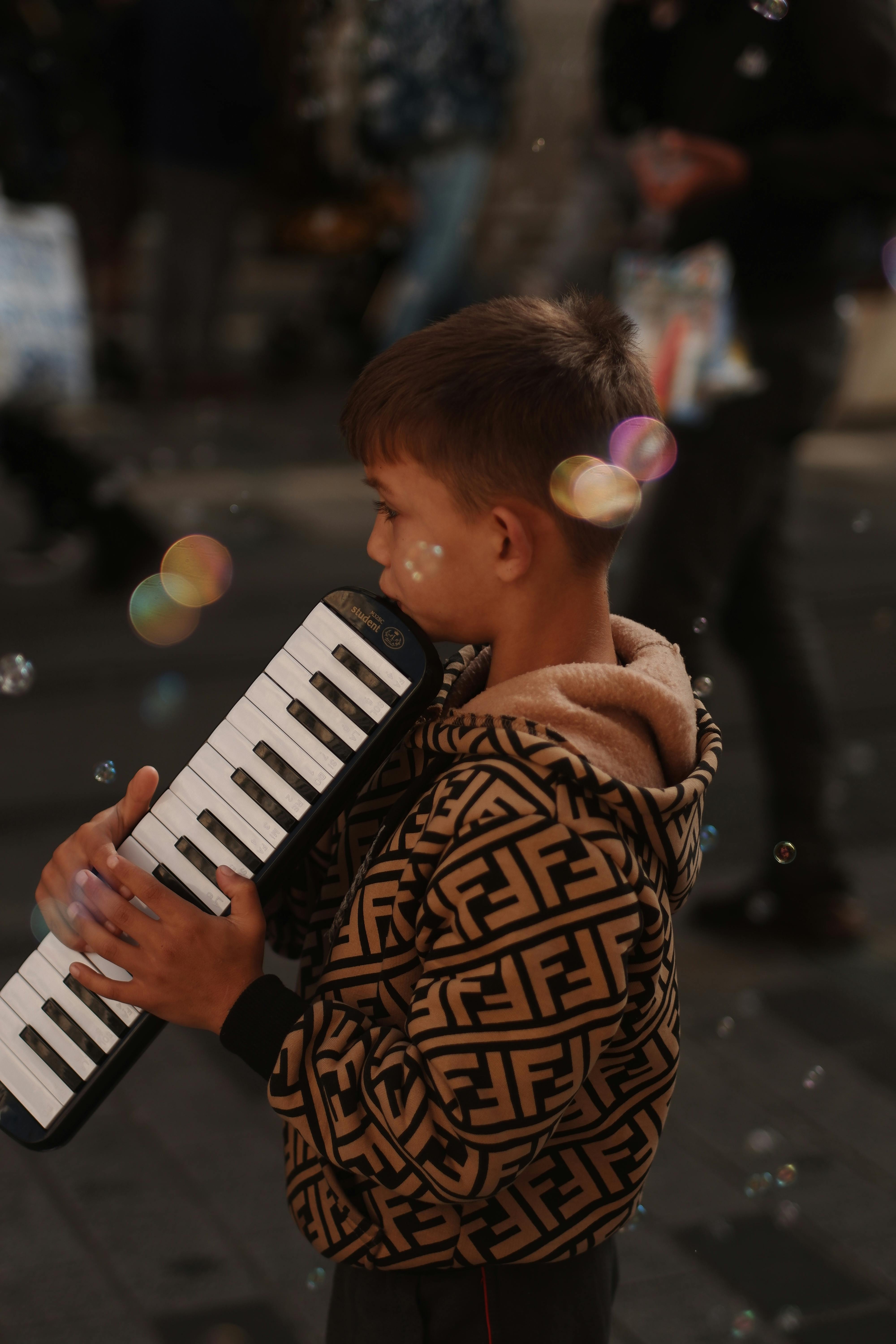 A Boy Playing Melodica · Free Stock Photo