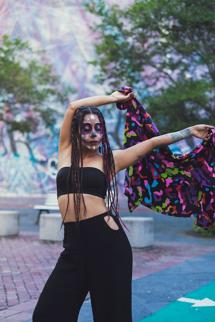 Woman With Face Painted Holding Shirt